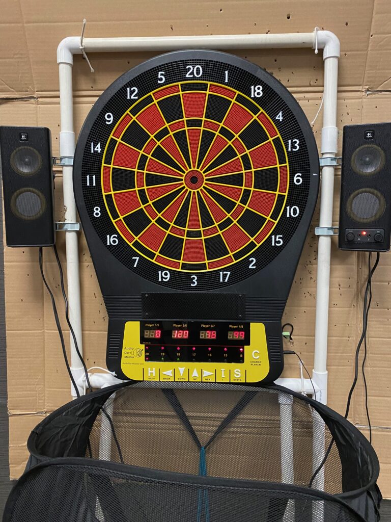 Dart board with speakers and basket